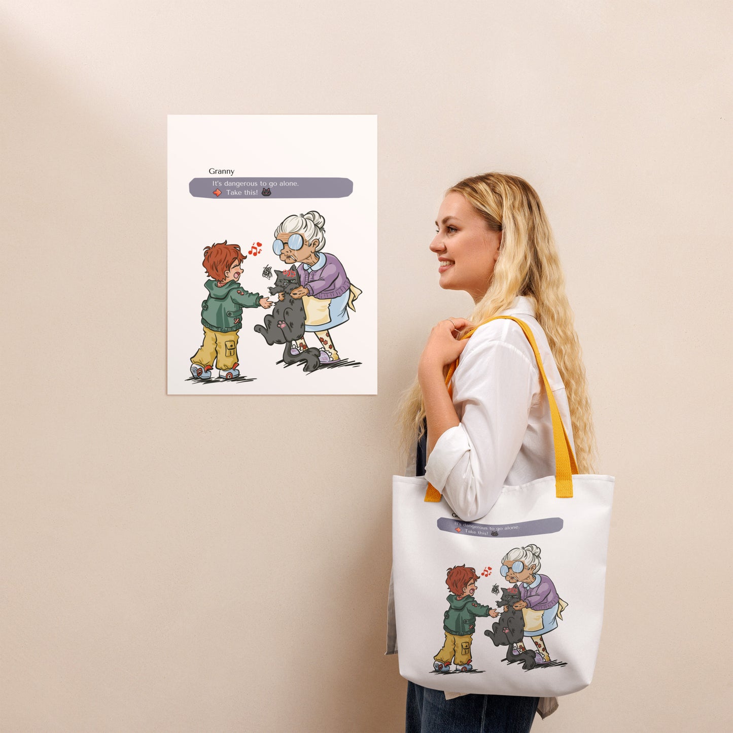 Womand wearing a white totebag with yellow handles. The illustration of a granny passing a grumpy cat to her way-to-happy grand-son is on the front of the bag. The discussion goes like "It's dangerous to go alone, Take this!" referring to the Zelda game.