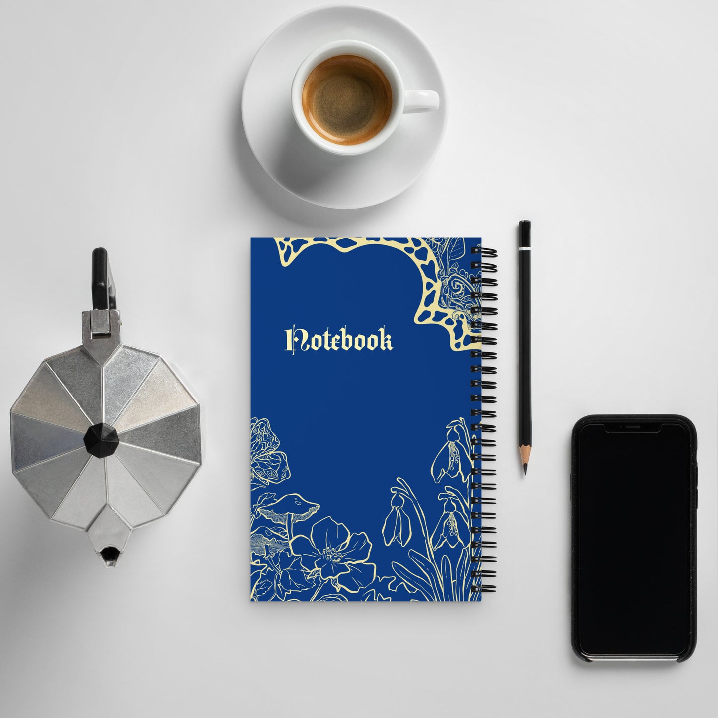 Back cover of the spiral notebook, with light yellow detailed illustration on a navy blue background.