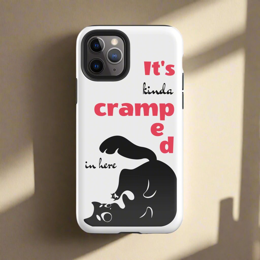 White phone case featuring a black cat trying to fit in the case corner. The funny words "It's kinda cramped in here" are present on the case.