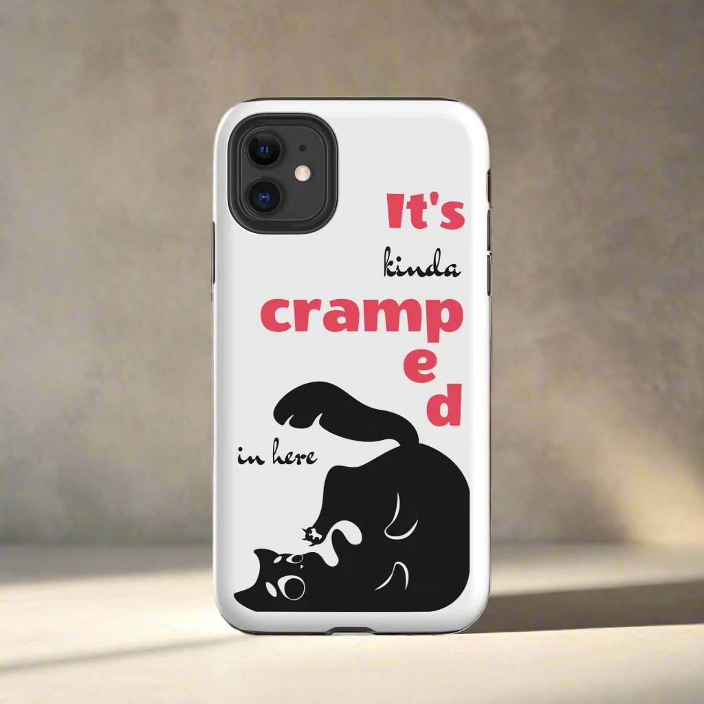 White phone case featuring a black cat trying to fit in the case corner. The funny words "It's kinda cramped in here" are present on the case. 