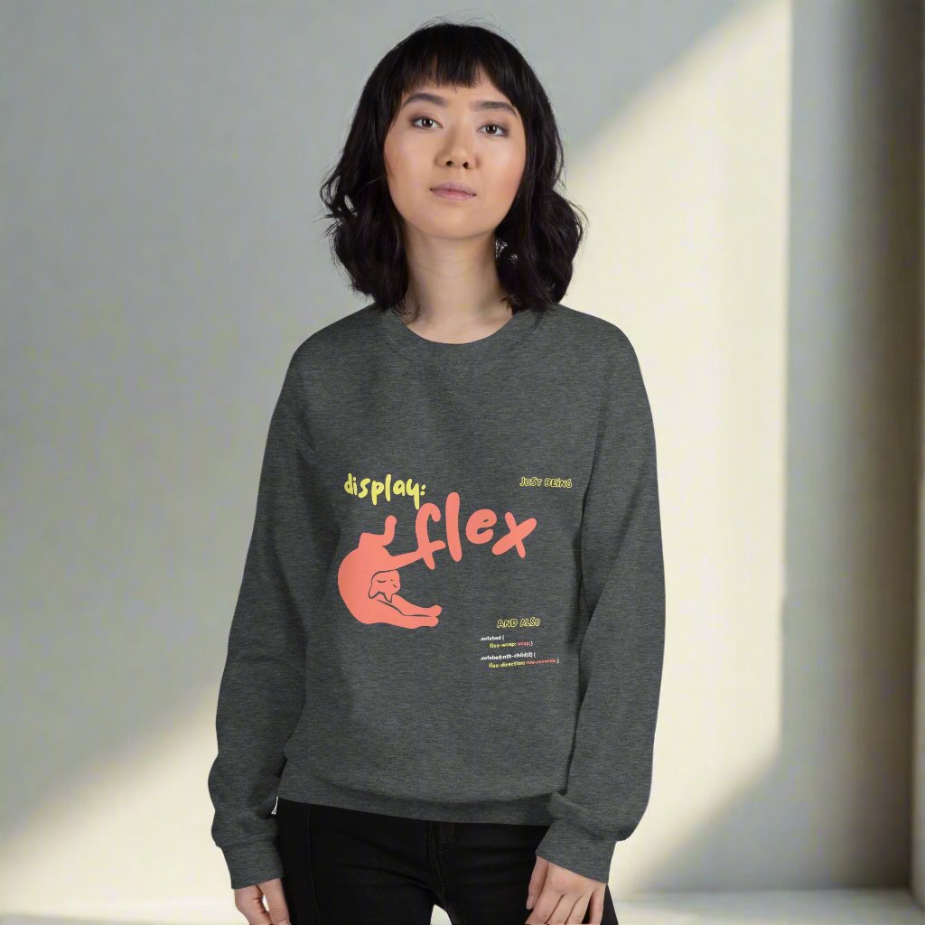 Woman wearing a grey crew neck sweatshirt featuring a stretching cat with the title "Just bein' Display: flex". Funny pun about cat being flexible and the css command.