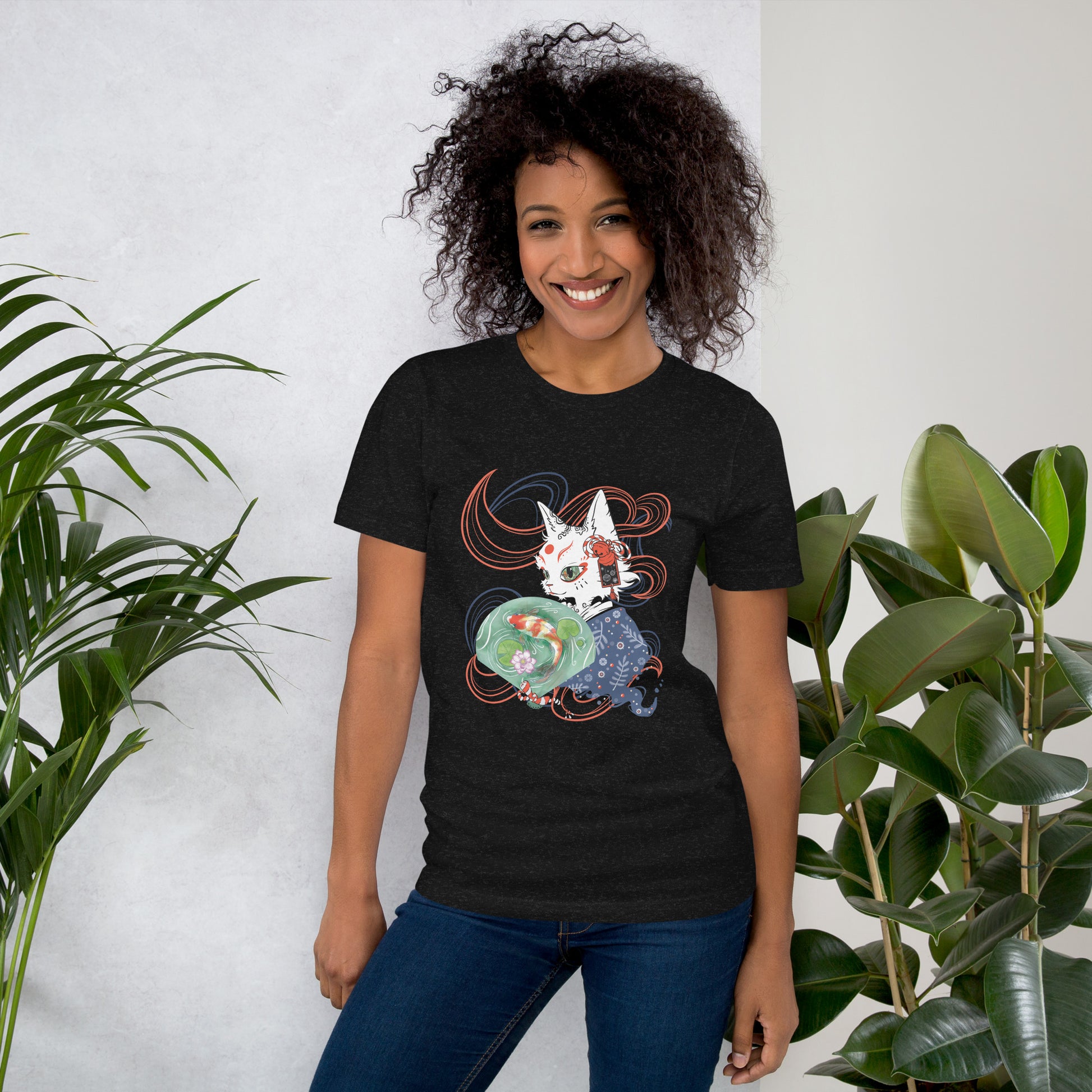 Woman wearing a black T-shirt with a digital illustration of a folklore Japanese cat monster Bakeneko, dressed in a blue patterned kimono. The fan its holding has a koi fish swimming in a pond. Colored waves are displayed on the dark background.